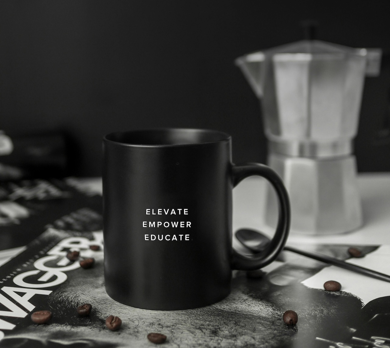 A photo of a mug saying ‘Elevate, Empower, Educate’
